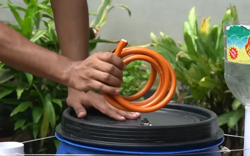 How to Build 2 Cheap Biogas Systems with Plastic Barrels 5 output hose