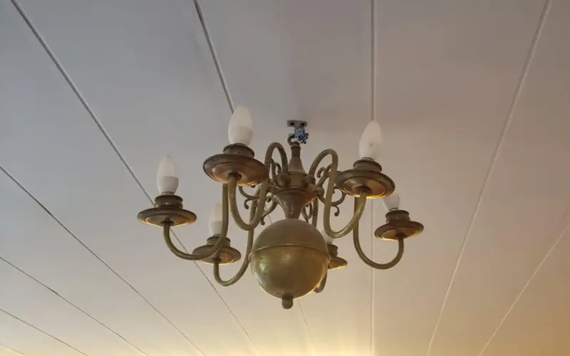 image of a matt white ceiling with chandelier